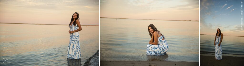 Editorial senior portrait of high school senior wearing a blue and white maxi dress on the beach at sunset during a senior photography session in Chatham, Cape Cod, Massachusetts with Jennifer Helmka, Photographer.